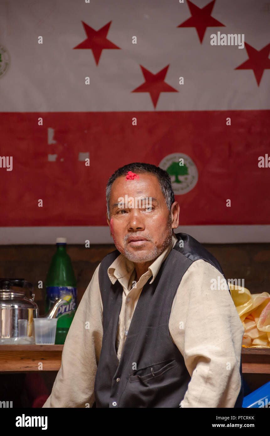 Nepalese man sitting in open room in Bhaktapur in Nepal Stock Photo
