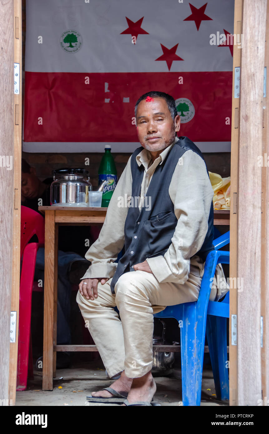 Nepalese man sitting in open room in Bhaktapur in Nepal Stock Photo