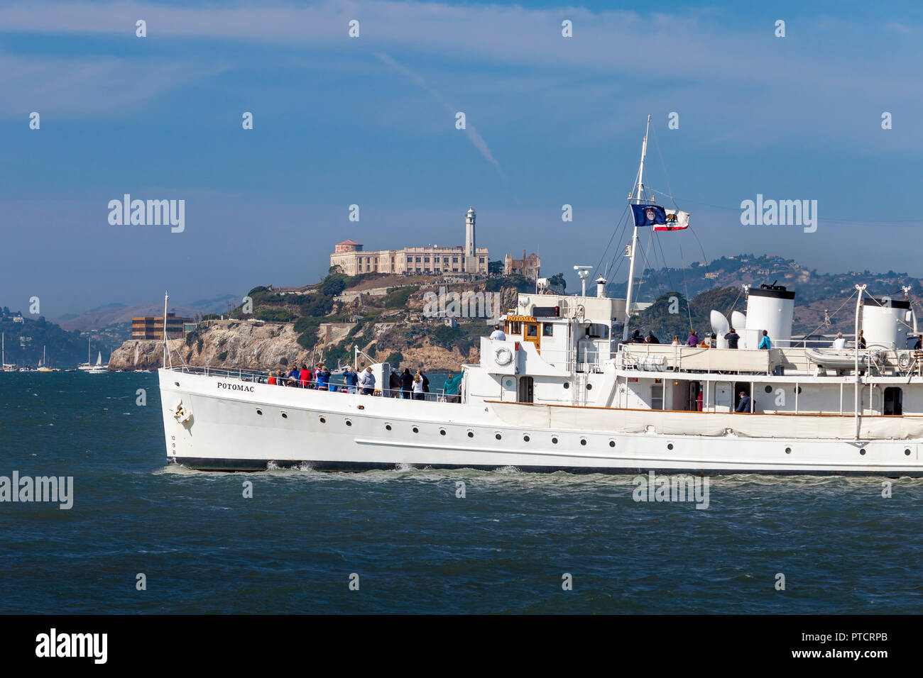 USS Potomac (AG-25) - Franklin Delano Roosevelt's yacht, launched 1934, sails past Alcatraz Prison in San Francisco Bay, California, USA Stock Photo