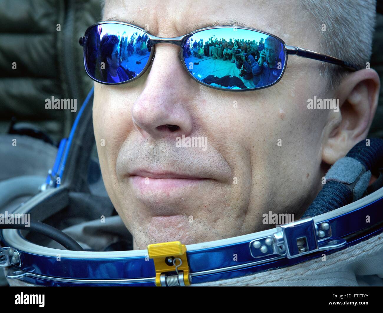 International Space Station Expedition 56 astronaut Drew Feustel rests outside the Russian Soyuz MS-08 spacecraft shortly after landing October 4, 2018 near Zhezkazgan, Kazakhstan. Stock Photo
