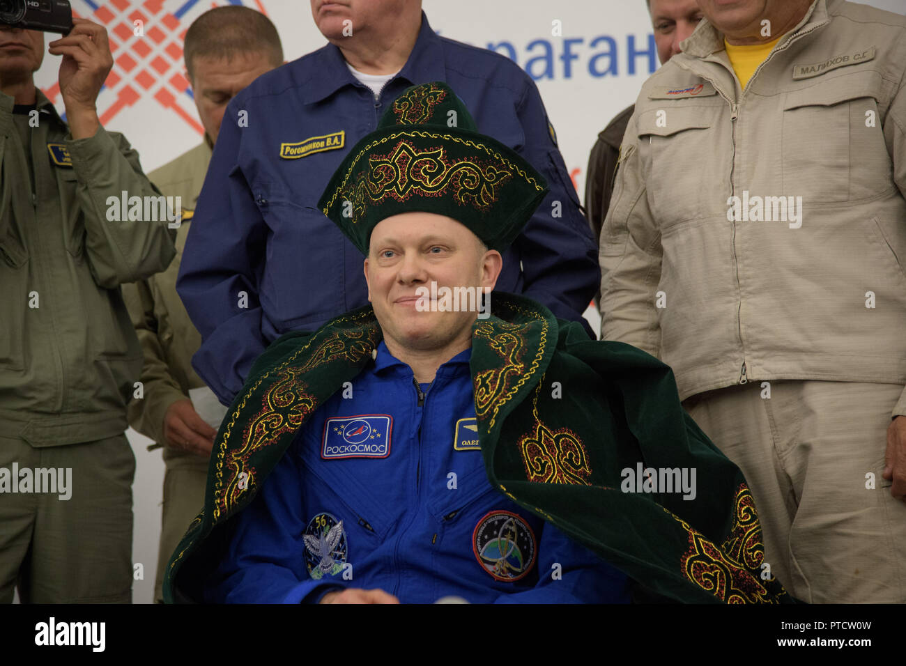 International Space Station Expedition 56 cosmonaut Oleg Artemyev rests dressed in traditional Kazakh clothing during the arrival ceremony at Karaganda Airport shortly after landing in the Russian Soyuz MS-08 spacecraft October 4, 2018 in Zhezkazgan, Kazakhstan. Stock Photo