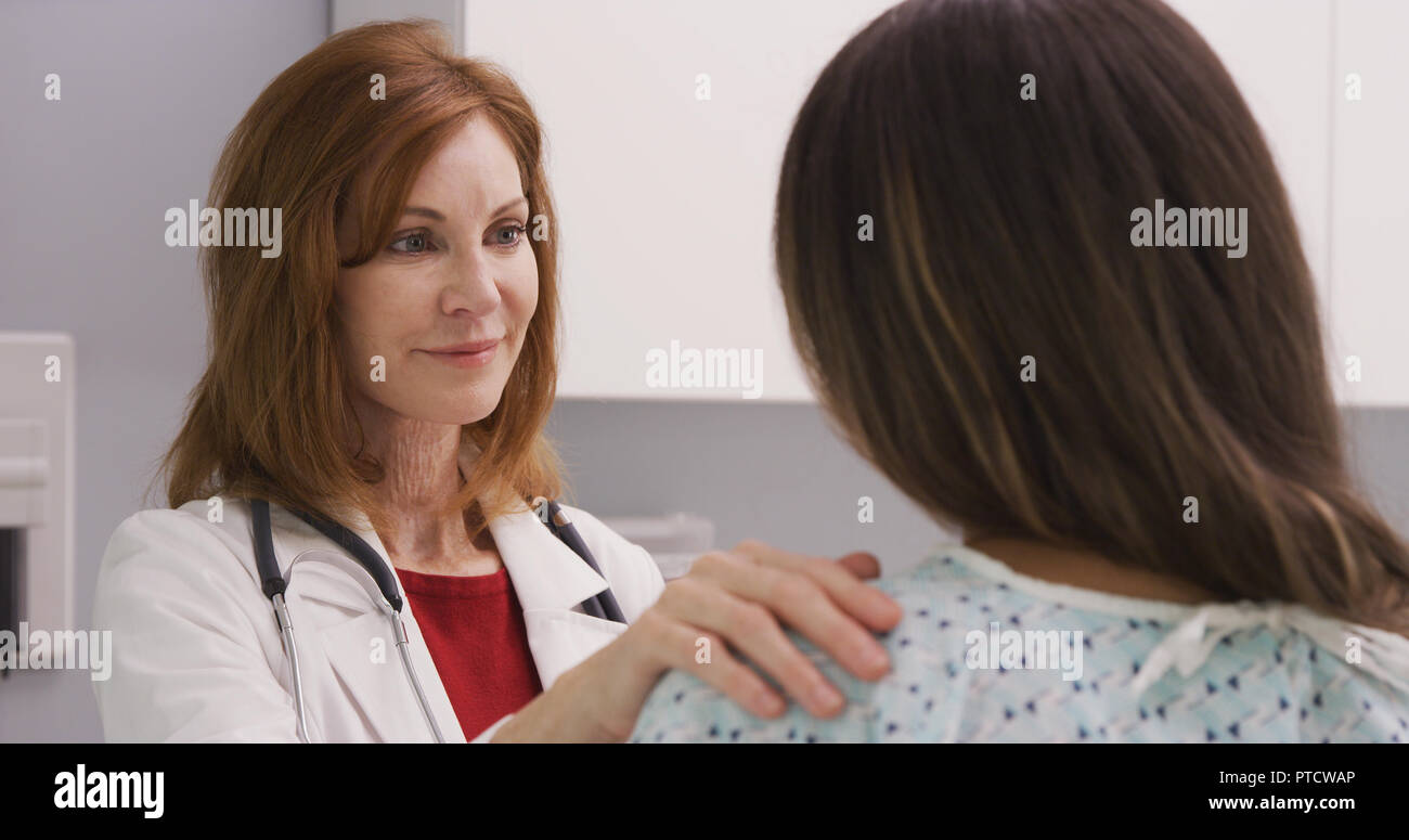 Lovely middle aged woman consoling young patient about dealing with trauma Stock Photo