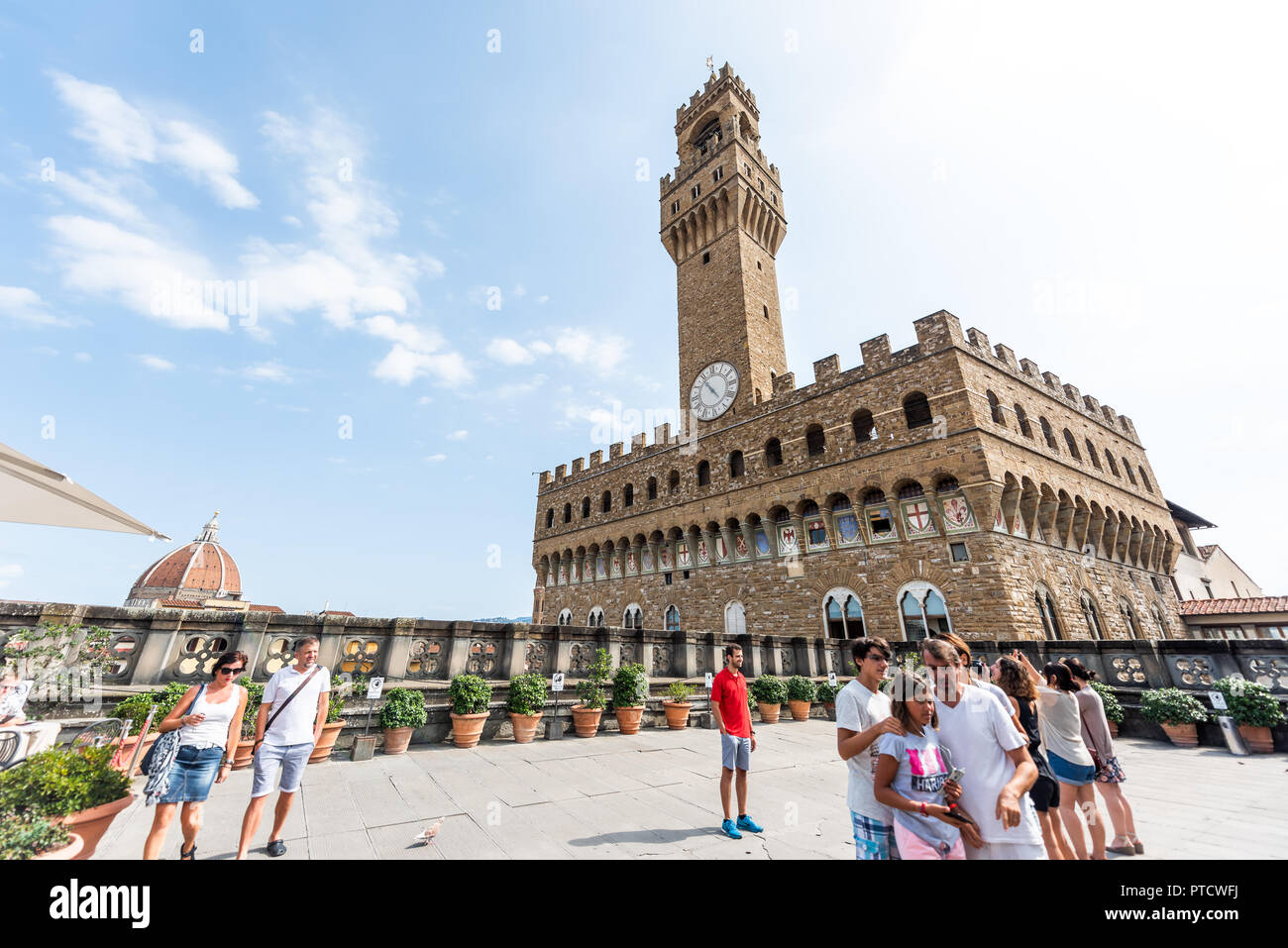 Firenze, Italy - August 30, 2018: Many people by cafe on terrace of famous Florence Uffizi art museum gallery with view of old building Palazzo Vecchi Stock Photo