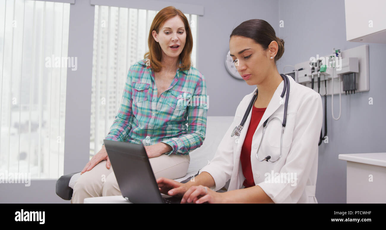 Close up of mid aged patient discussing with young female doctor health issues Stock Photo