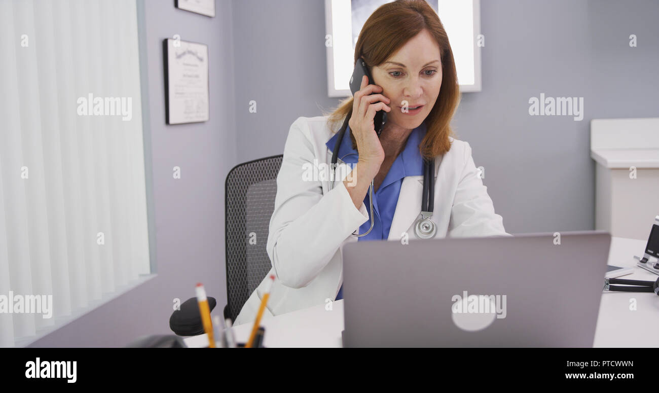 Close up of medical physician discussing with patient on phone her test results Stock Photo