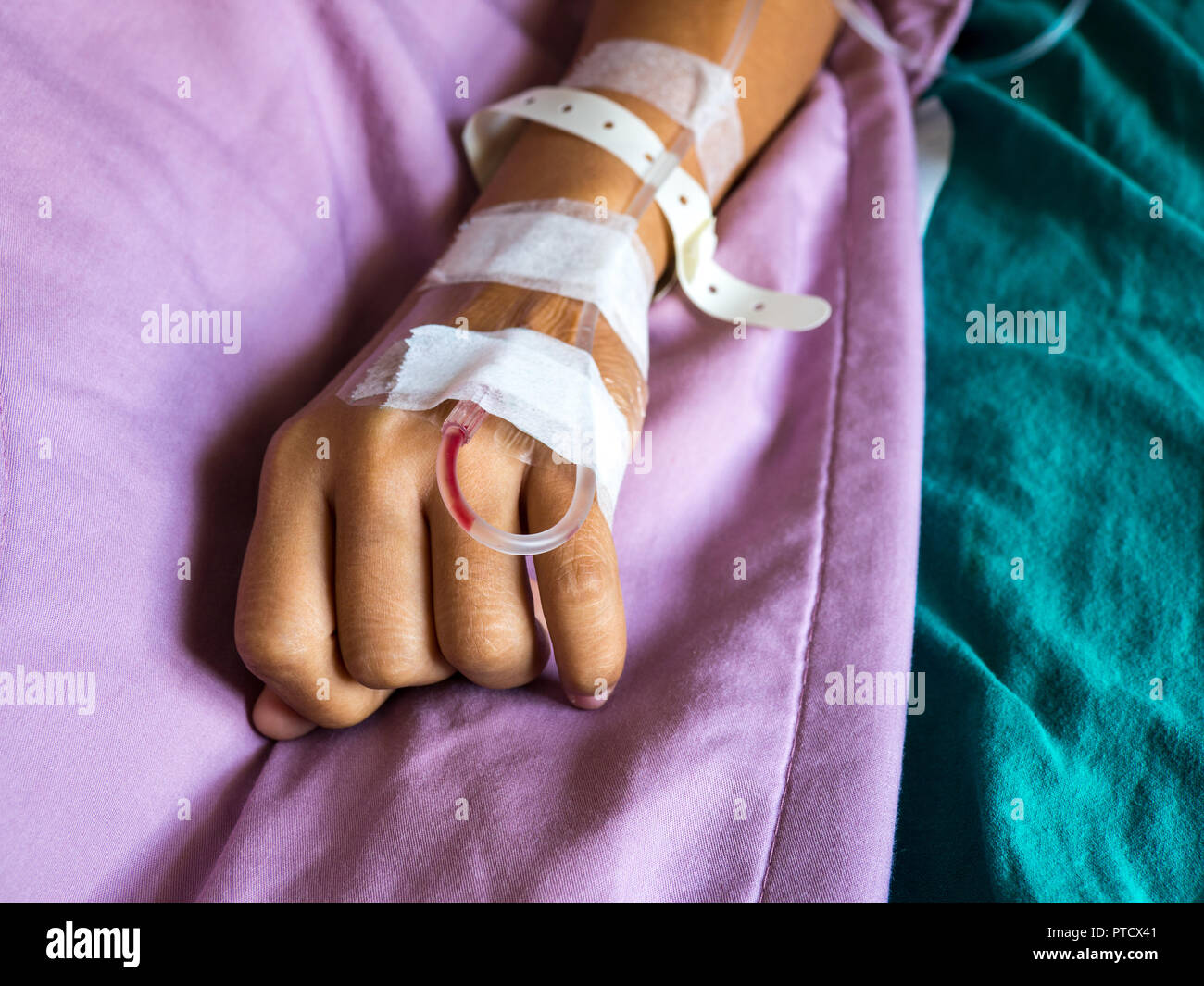 Close up hand of asian woman patient with drip receiving for injection