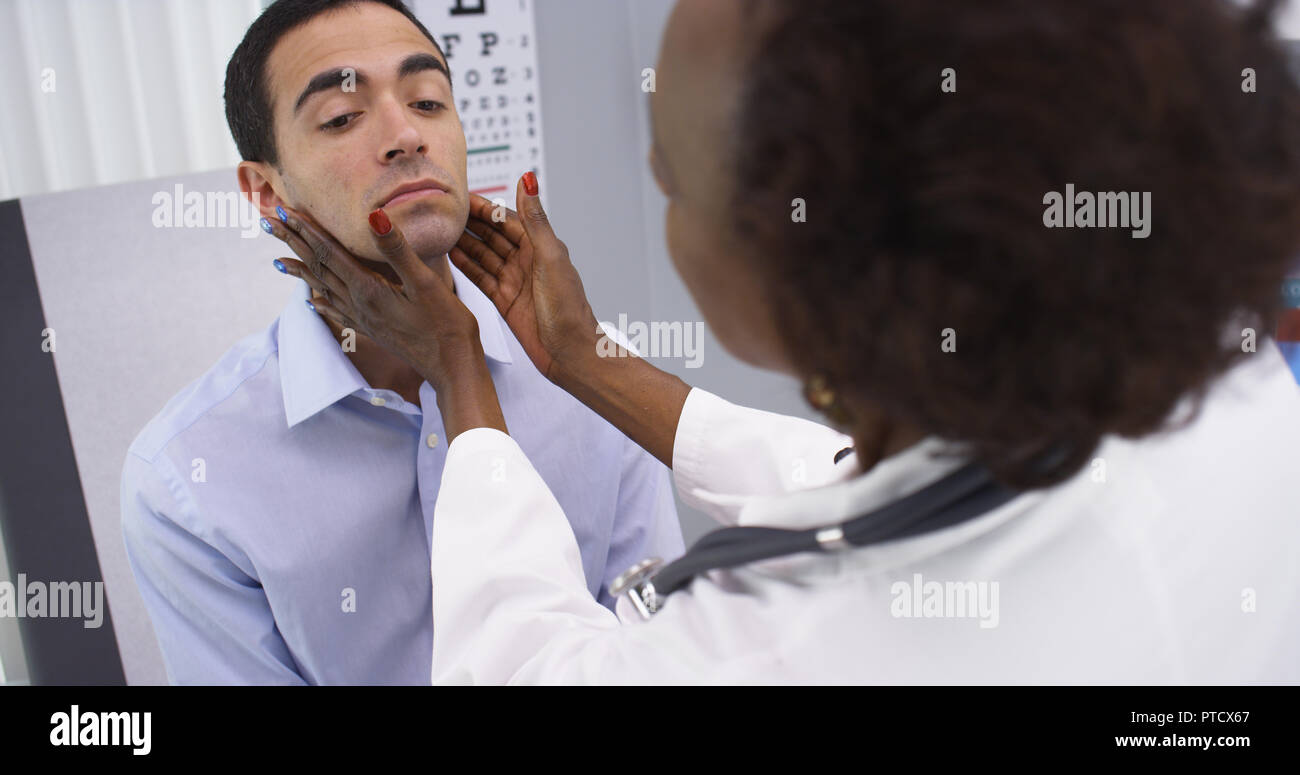 Young latino male patient having routine health checkup Stock Photo