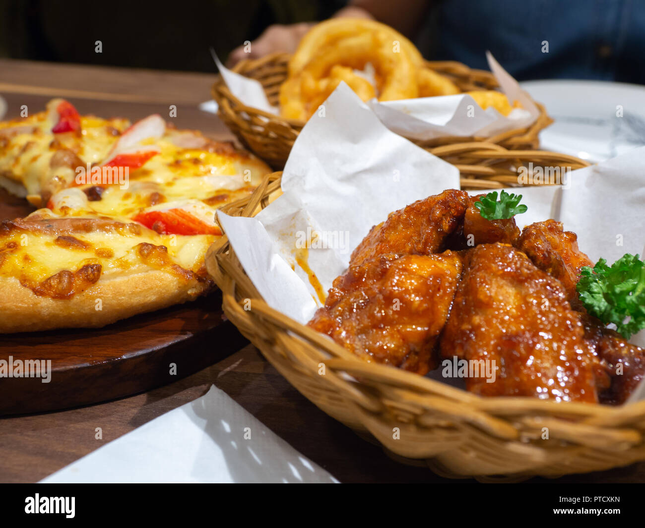 Deep fried chicken in a basket with parsley and seafood pizza topping