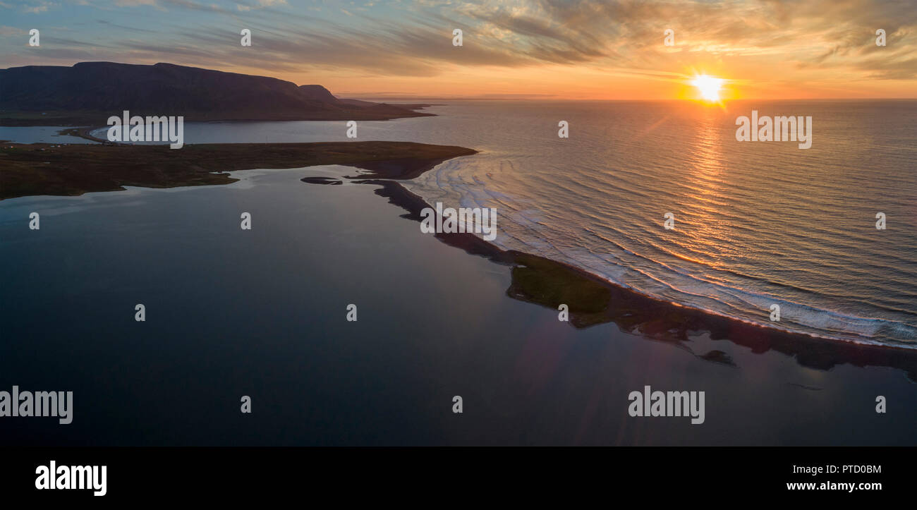 Sunset over the sea, Lake Miklavatn with bay of Miklavatn near Fell, North Iceland, Iceland Stock Photo