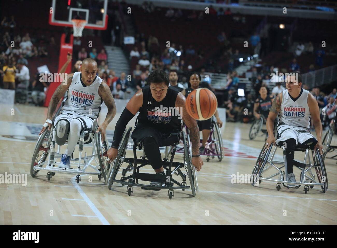 U.S. Army veteran Jarred Vaina, from American Samoa, goes after the basketball during the wheelchair  competition for the 2017 Department of Defense Warrior Games at Chicago, Ill., July 7, 2017. The DOD Warrior Games are an annual event allowing wounded, ill and injured service members and veterans in Paralympic-style sports including archery, cycling, field, shooting, sitting volleyball, swimming, track and wheelchair basketball. Stock Photo