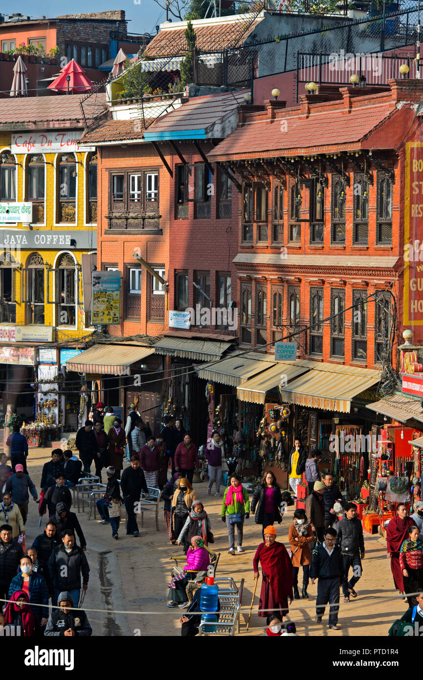 Lively shopping street with locals, restaurants and souvenir shops, walk around the Boudhanath Stupa, Kathmandu, Nepal Stock Photo