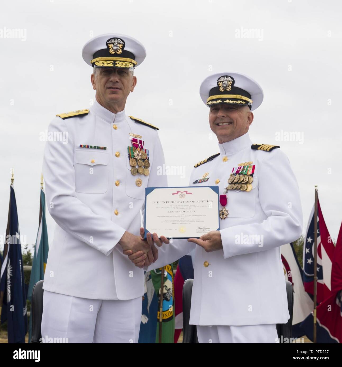 OAK HARBOR, Wash. (July 7, 2017) Rear Adm. Paul Pearigen, commander, Navy Medicine West, presents the Legion of Merit award to Capt. Frederick McDonald during the Naval Hospital Oak Harbor change of command ceremony at Naval Air Station Whidbey Island. Capt. Christine Sears relieved Capt. Frederick McDonald as the commanding officer of Naval Hospital Oak Harbor. Stock Photo