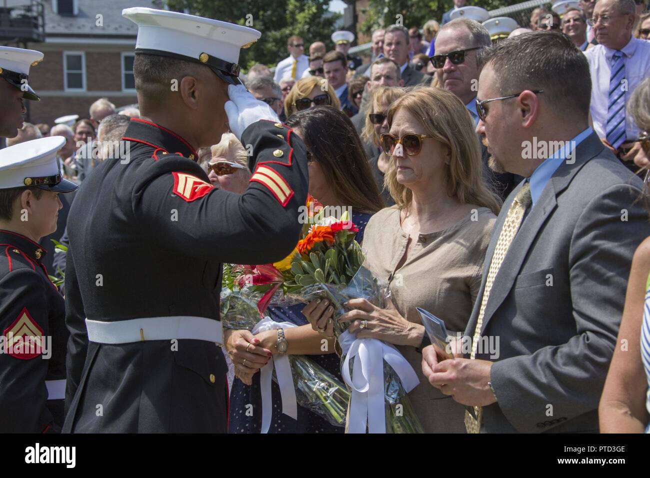 U.S. Marines with Marine Barracks Washington (MBW) present flowers to the family of Lt. Gen. Jon M. Davis, deputy commandant of Aviation, MBW, Washington, D.C., July 10, 2017. Davis retired after 40 years of service in the U.S. Marine Corps. Stock Photo