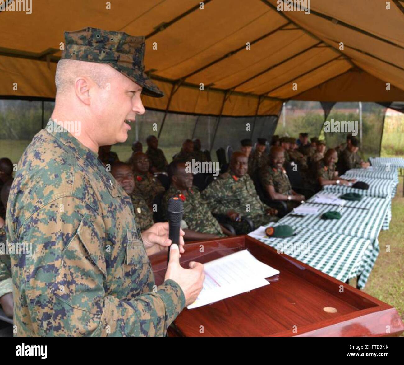 Combined Joint Task Force-Horn of Africa commander U.S. Marine Corps Brig. Gen. David Furness gives remarks to a crowd including Uganda People’s Defense Force leadership, staff, as well as students who graduated July 7, 2017, from a two-month engineering course in Jinja, Uganda. The Class 17.2 graduation was historic because it marked the conclusion of the first class where UPDF instructors both ran and taught the entire course, advised by U.S. Marine Corps partners from the Special Purpose Marine Air-Ground Task Force-Crisis Response-Africa. The course covered three subjects, including civil  Stock Photo