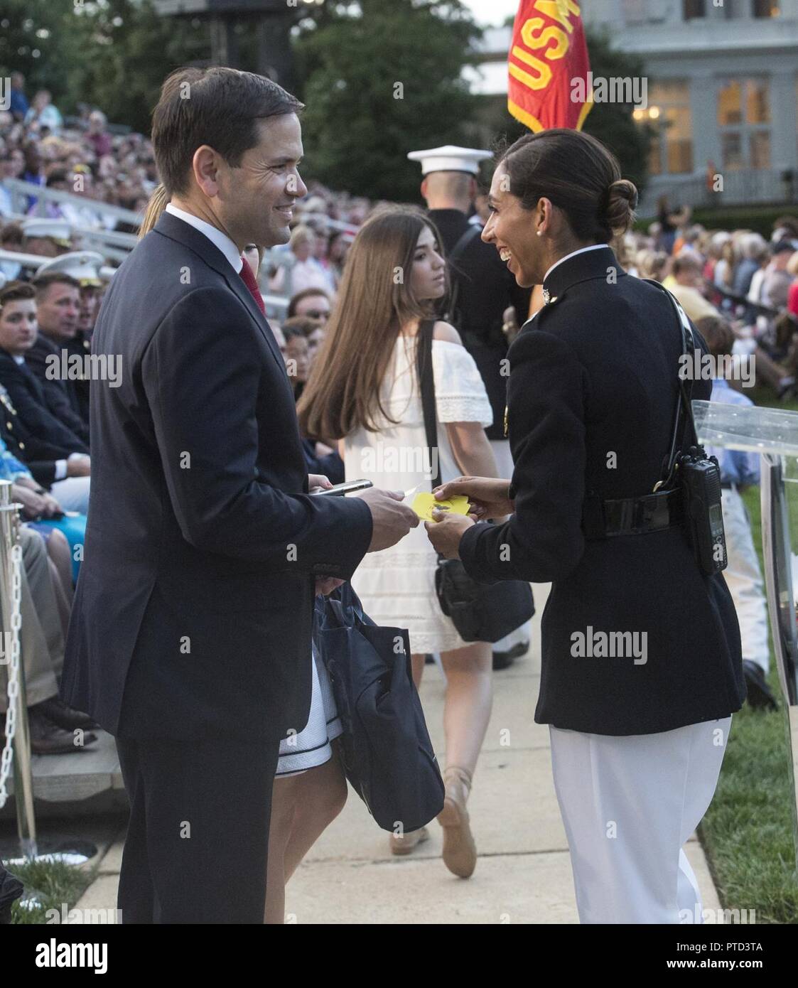 Captain Desiree K. Sanchez, protocol director, Marine Barracks Washington D.C., escorts the Honorable Marco Rubio, United States Senator for Florida, and his wife, Mrs. Jeanette Dousdebes Rubio, to their seats before a Friday Evening Parade at the Barracks, July 7, 2017. The guest of honor for the parade was Mr. Timothy Day, chairman and founder of Bar-S Foods Company and chairman of the Timothy T. Day Foundation, and the hosting official was Lt. Gen. Kenneth McKenzie, director for Strategic Plans and Policy. Stock Photo