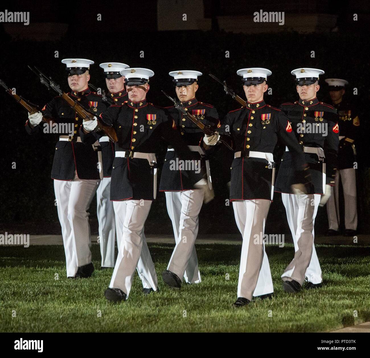 Marines with the U.S. Marine Corps Silent Drill Platoon execute precision rifle drill movements