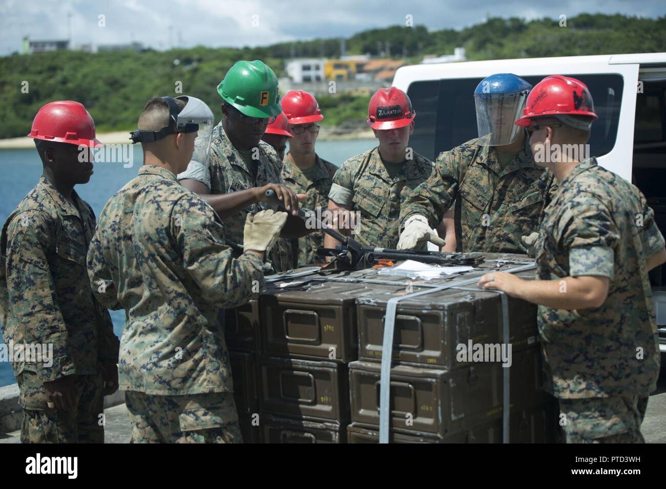 U.S. Marines conduct a movement of unserviceable ammunition, July 11, 2017, from the Ammunition Supply Point on Camp Schwab, Okinawa, Japan to a United States Naval Ship at Tengan Pier, Okinawa, Japan. The Marines with Ammunition Company, 3d Supply Battalion, Combat Logistics Regiment 35, 3d Marine Logistics Group, III Marine Expeditionary Force loaded up approximately 130 pallets of ammunition at the ASP to be transported and returned to the Naval Munitions Command on Sasebo Navy Base, Japan, for proper disposal. The experience of a ship-to-shore ammo movement is unique to the Marines with II Stock Photo