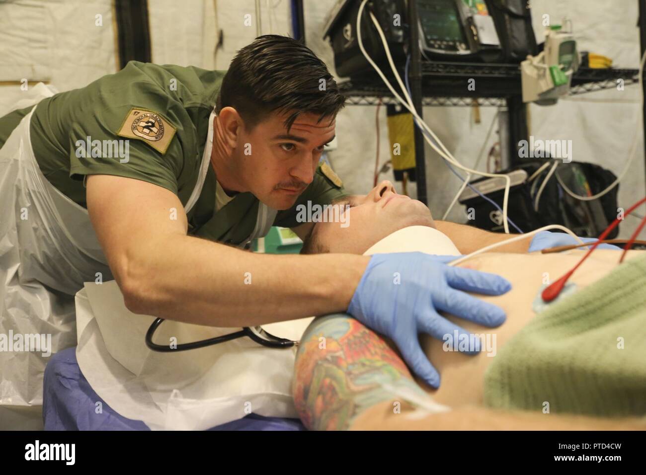 Corporal James Gummow, a medic with 2nd General Health Battalion, 17th Combat Service Support Brigade, evaluates a patient with a simulated sternum fracture during a mass casualty exercise at Williamson Air Field, Shoalwater Bay Training Area, Queensland, Australia, July 8, 2017 during Talisman Saber 17. Australian Army soldiers with 17th CSS Brigade conducted a mass-casualty exercise at Williamson Air Field hospital to practice Role 2 advanced trauma care and procedures that are used in a deployed environment. Exercises like Talisman Saber provide effective and intense training to ensure our  Stock Photo