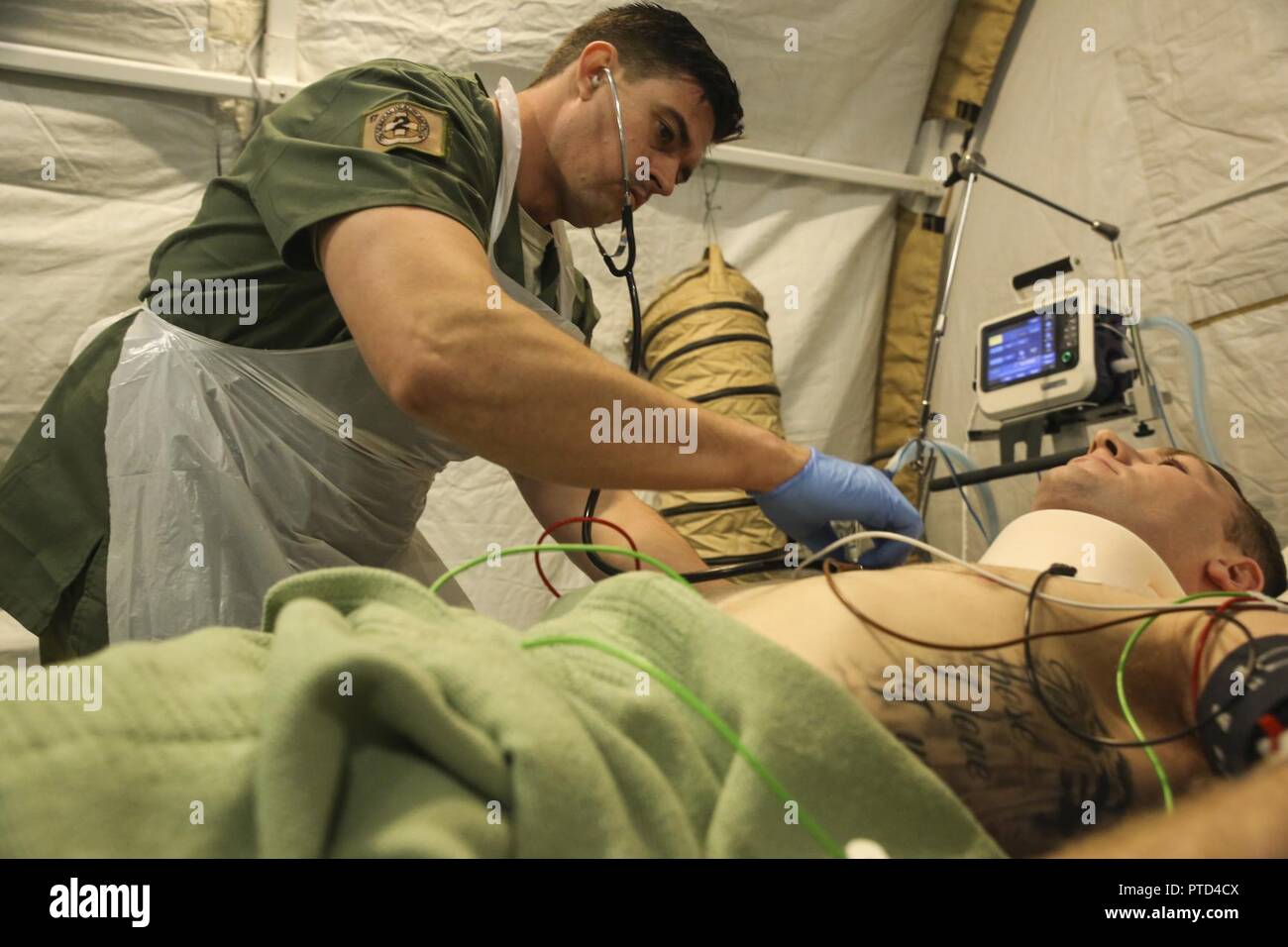 Corporal James Gummow, a medic with 2nd General Health Battalion, 17th Combat Service Support Brigade, evaluates a patient with a simulated sternum fracture during a mass casualty exercise at Williamson Air Field, Shoalwater Bay Training Area, Queensland, Australia, July 8, 2017 during Talisman Saber 17. Australian Army soldiers with 17th CSS Brigade conducted a mass-casualty exercise at Williamson Air Field hospital to practice Role 2 advanced trauma care and procedures that are used in a deployed environment. Exercises like Talisman Saber provide effective and intense training to ensure our  Stock Photo