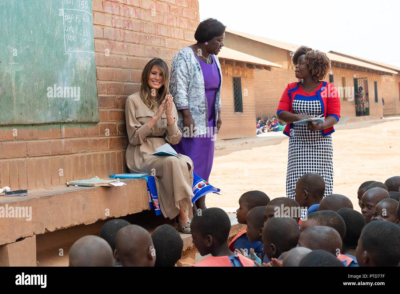 U.S First Lady Melania Trump and Headmistress Maureen Masi watch an outdoor classroom learning the English and Chichewa languages at the Chipala Primary School October 4, 2018 in Lilongwe, Malawi. This is the first solo international trip by the First Lady. Stock Photo