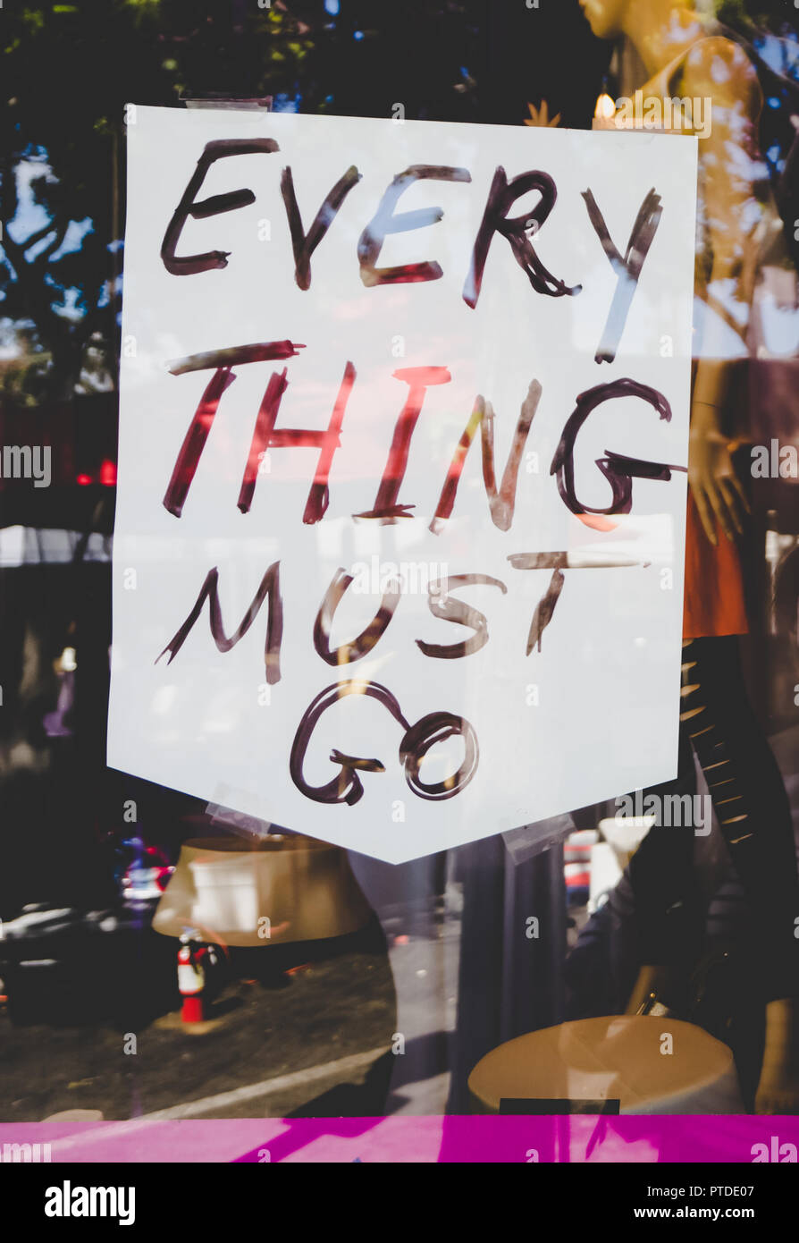 'Everything Must Go' 'Blowout Sale' 'Store Closing' Signs in store window and on the sidewalk. Economic depression. Stock Photo