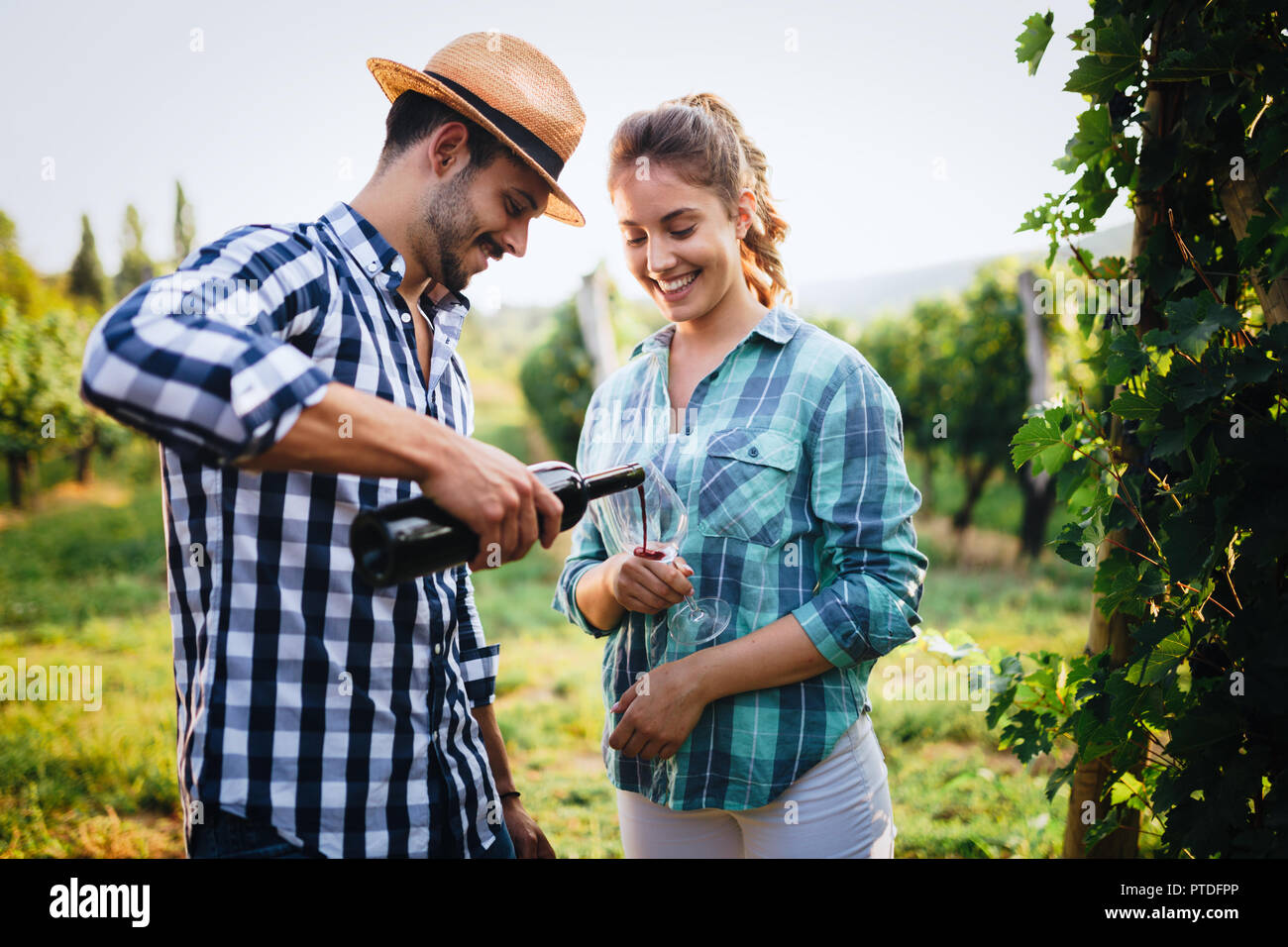 Wine tourists tasting wine in vineyard and smiling Stock Photo - Alamy
