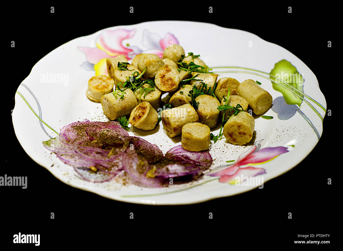 Chicken Sausages served with Onion Salad in a platter Stock Photo