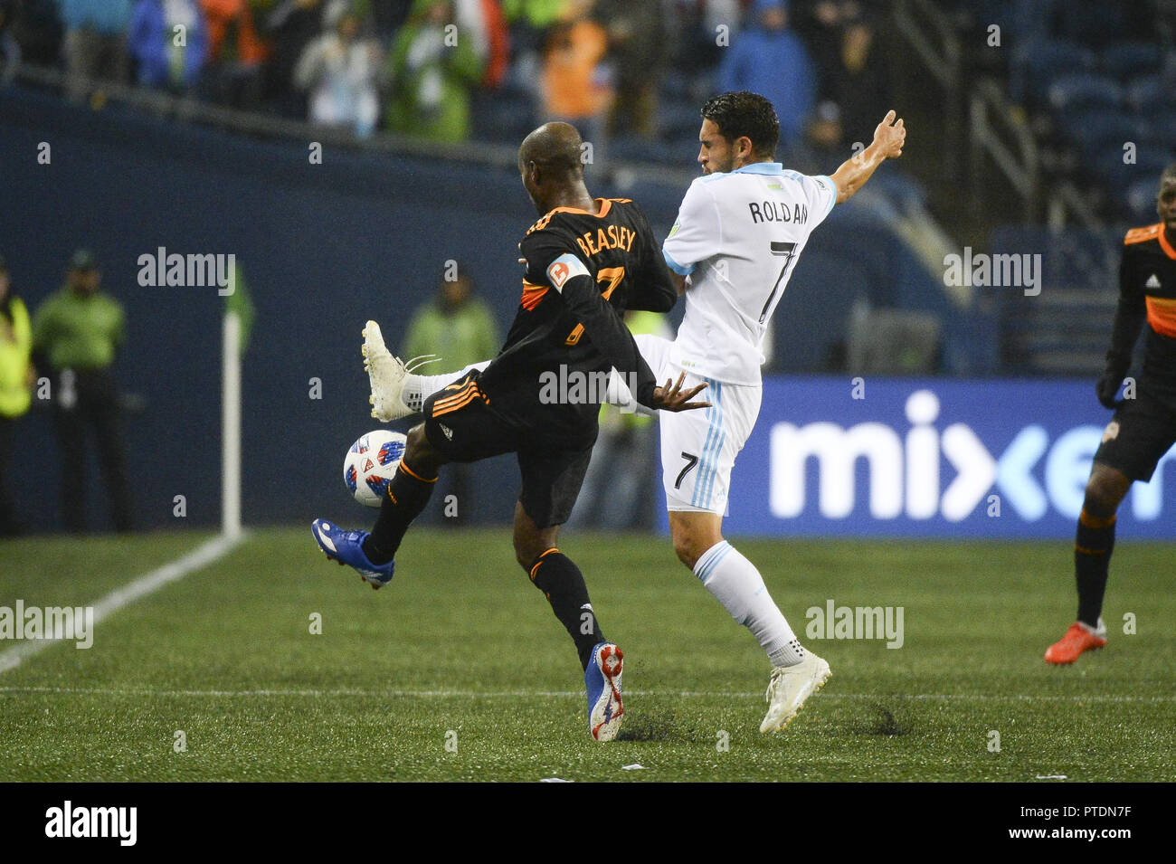 Seattle, Washington, USA. 8th Oct, 2018. Seattle's CRISTIAN ROLDAN (7) and Houston's DAMARCUS BEASLEY (7) battle for a loose ball as the Houston Dynamo visits the Seattle Sounders in a MLS match at Century Link Field in Seattle, WA. Credit: Jeff Halstead/ZUMA Wire/Alamy Live News Stock Photo