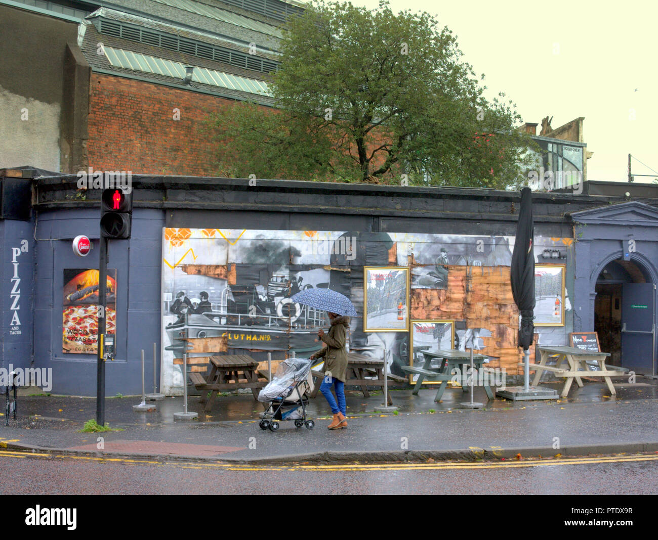 Glasgow, Scotland, UK, 9th October, 2018. UK Weather: Rain and wind over the last few days have taken their toll on the famous mural of the Clutha bar helicopter tragedy scene with parts of the Stan Laurel portrait suffering from the windy wet weather.The famous people depicted have a connection directly with the bar or city. Gerard Ferry/Alamy news Credit: gerard ferry/Alamy Live News Stock Photo
