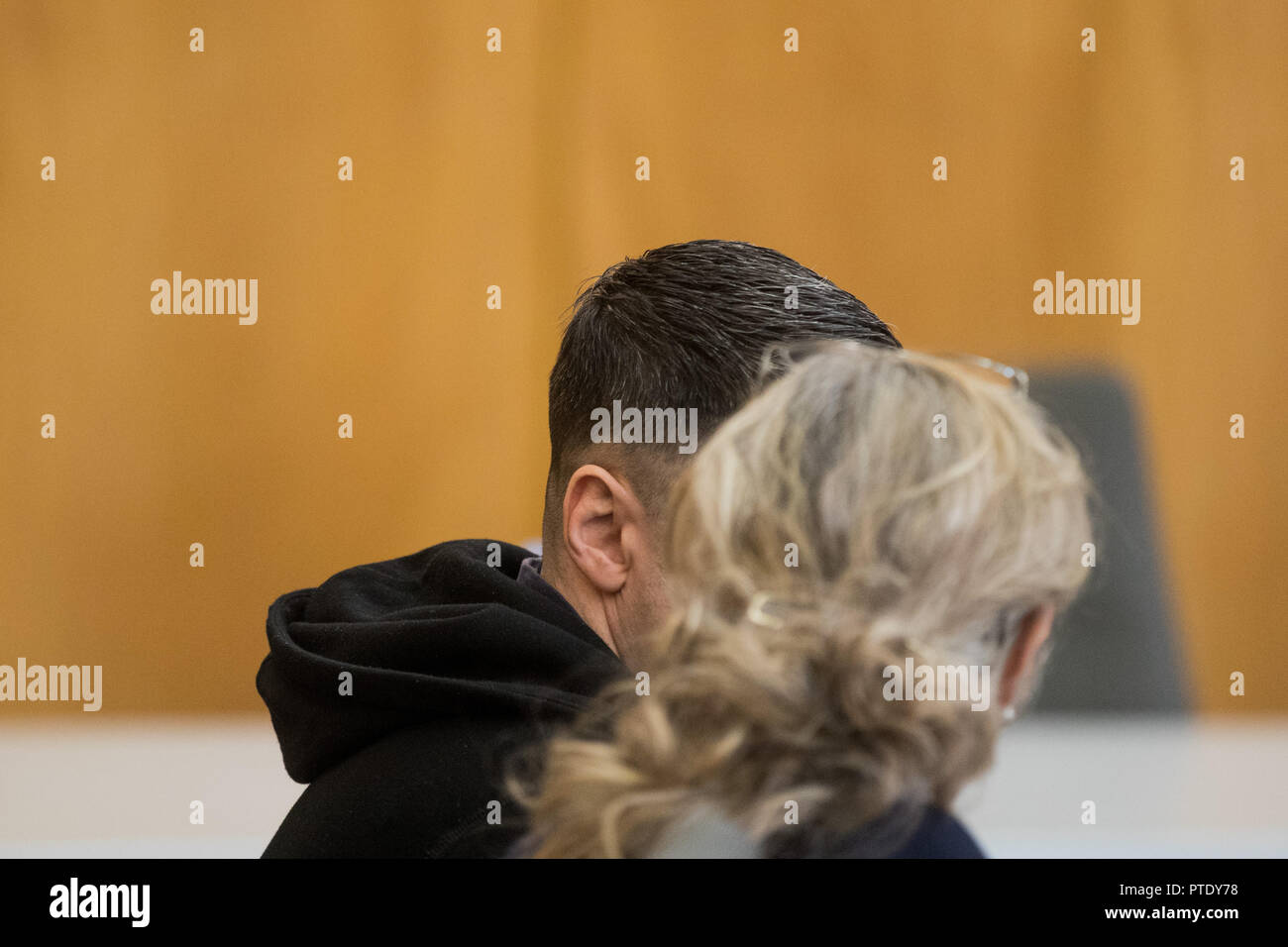 09 October 2018, North Rhine-Westphalia, Essen: The accused of attempted murder, a suspected contract killer, sits next to a translator in the district court. The 45-year-old man from Belarus allegedly tried to shoot another man in February 2001 in Bottrop with an accomplice. The victim suffered gunshot wounds to arm and ear. The defendant had been extradited by Russia at the beginning of 2018. Photo: Rolf Vennenbernd/dpa Stock Photo
