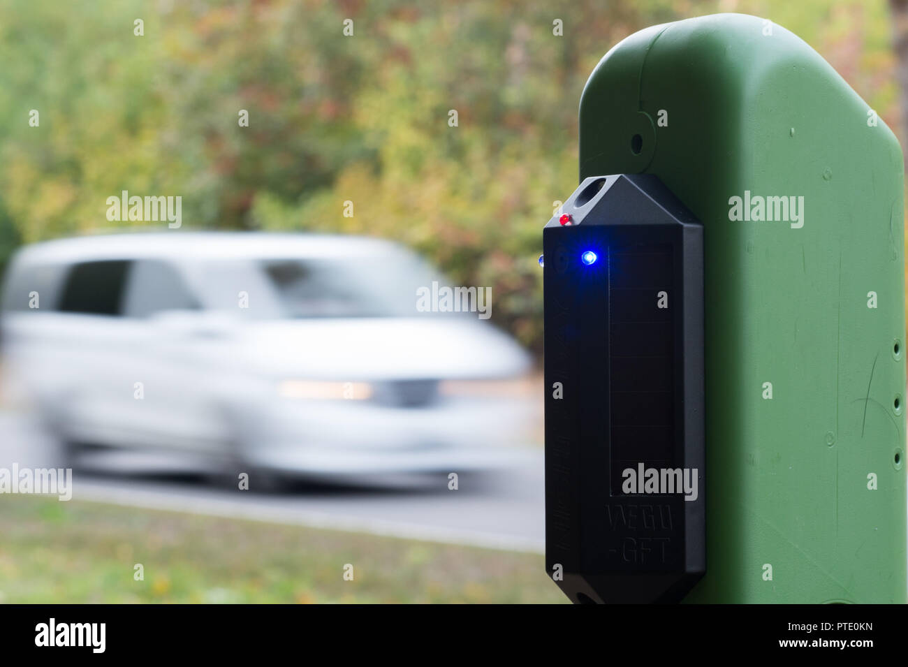 09 October 2018, Saxony-Anhalt, Tornau: A game warner mounted on a green support post emits an acoustic and visual signal as a vehicle approaches. The signals have a disturbing effect on game and should prevent the animals from crossing the road. According to the State Ministry of Transport, this is the first project in Germany to combine such acoustic wildlife warners with optical reflectors.     (about dpa 'Beeping against the crash - pilot project on wildlife accidents started' 09.10.2018) Photo: Klaus-Dietmar Gabbert/dpa-Zentralbild/ZB Stock Photo