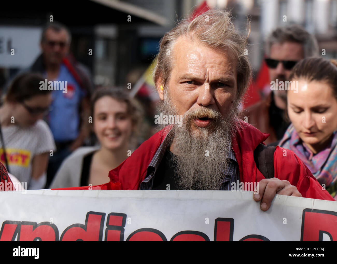 An elderly man seen holding a banner during the protest. People demonstrate during a one-day nationwide strike over French President Emmanuel Macron's policies in Strasbourg, eastern France. Stock Photo