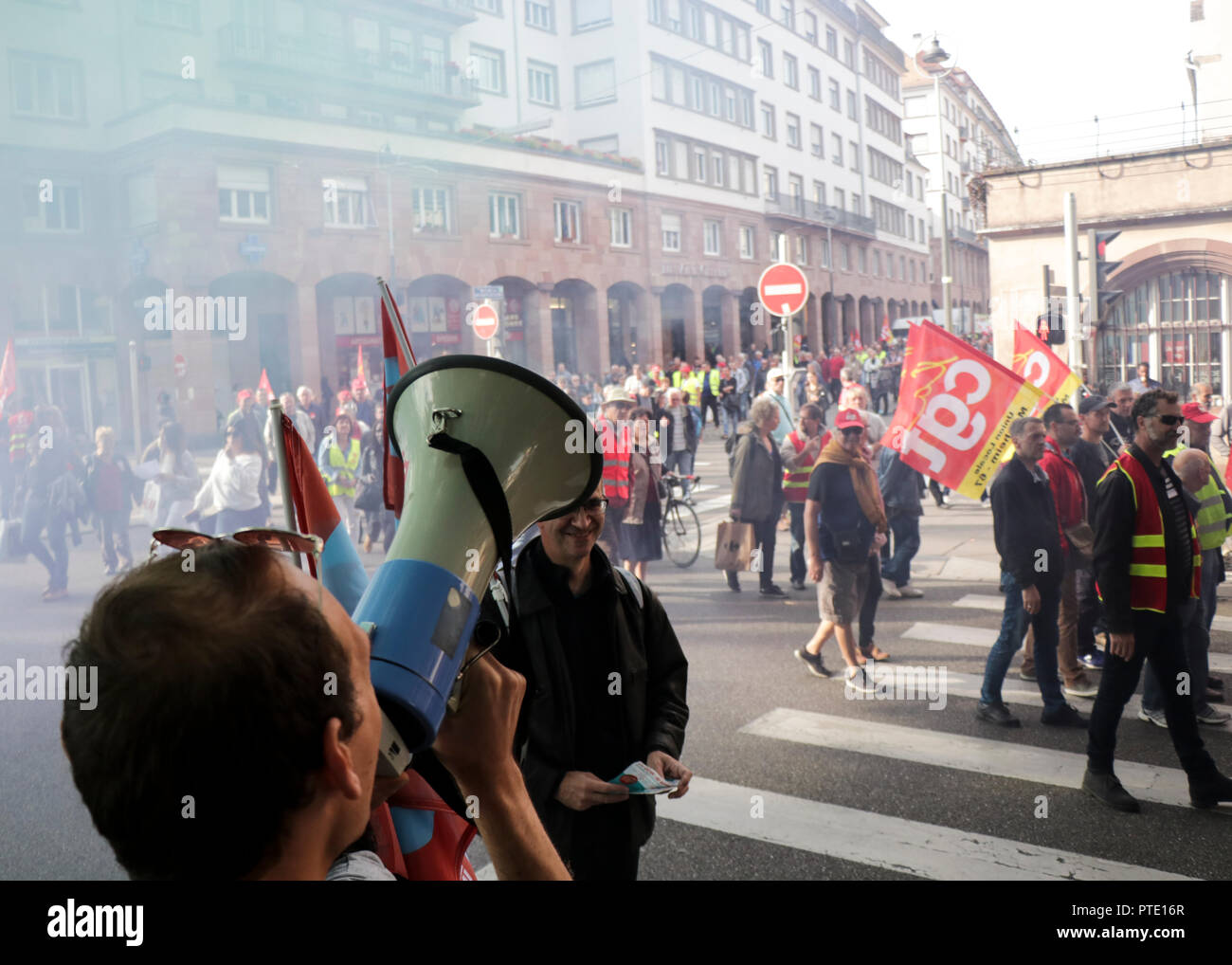 A man seen speaking on a megaphone during the protest. People demonstrate during a one-day nationwide strike over French President Emmanuel Macron's policies in Strasbourg, eastern France. Stock Photo