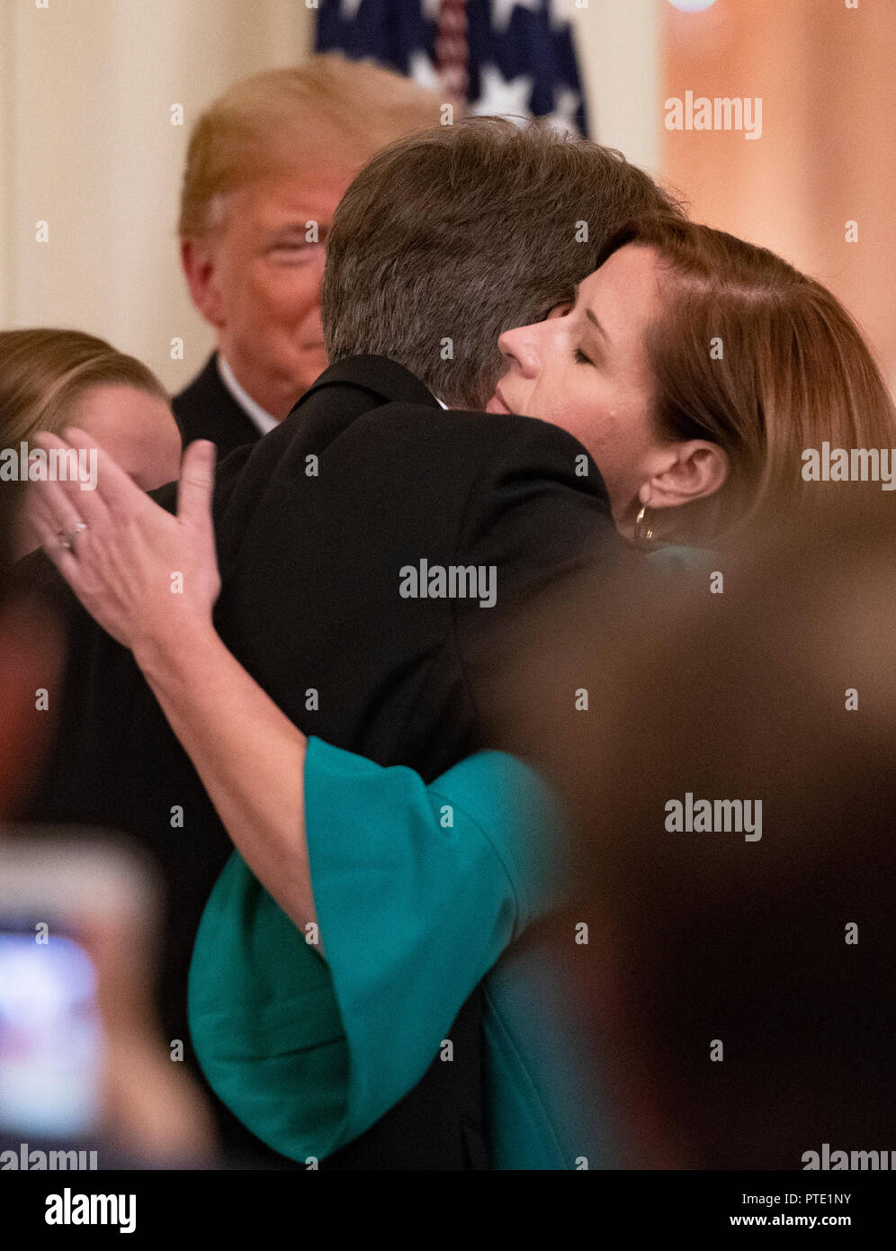 Ashley Kavanaugh hugs her husband Associate Justice of the Supreme Court Brett Kavanaugh after taking the Judicial Oath from former Associate Justice of the Supreme Court Anthony M. Kennedy in the East Room of the White House in Washington, DC on Monday, October 8, 2018. Kavanaugh formally took the oath on Saturday, hours after he was confirmed by the US Senate. US President Donald J. Trump looks on from the rear. Credit: Ron Sachs/CNP (RESTRICTION: NO New York or New Jersey Newspapers or newspapers within a 75 mile radius of New York City) | usage worldwide Stock Photo