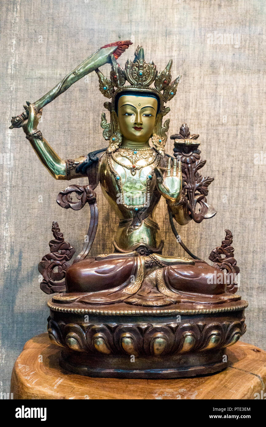 gold and bronze tibetan manjushri buddha statue Holding a sword Stock Photo