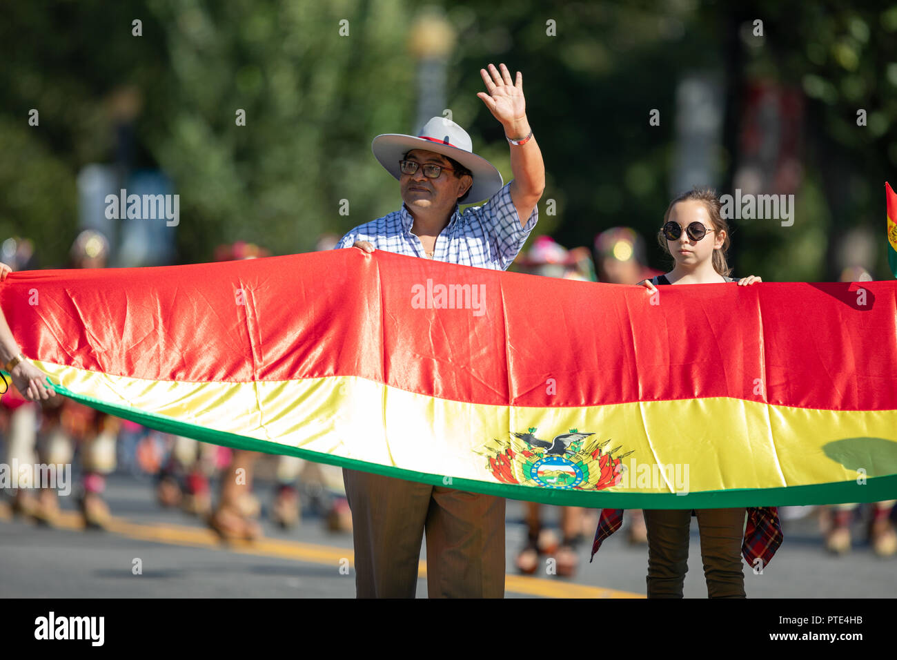 Washington, D.C., USA - September 29, 2018: The Fiesta DC Parade, Men and women carry the Bolivian national flag Stock Photo