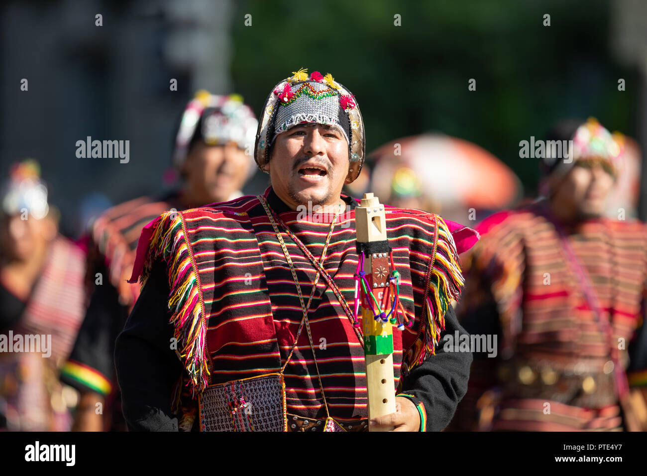 Washington, D.C., USA - September 29, 2018: The Fiesta DC Parade, Bolivian men wearing traditional clothing playing the Tarka, indigenous andes flute Stock Photo