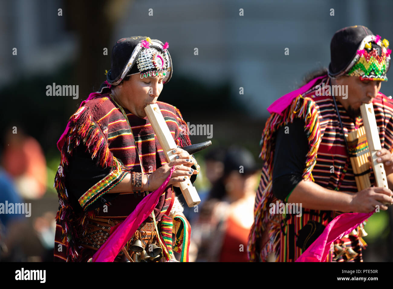 Washington, D.C., USA - September 29, 2018: The Fiesta DC Parade, Bolivian men wearing traditional clothing playing the Tarka, indigenous andes flute Stock Photo