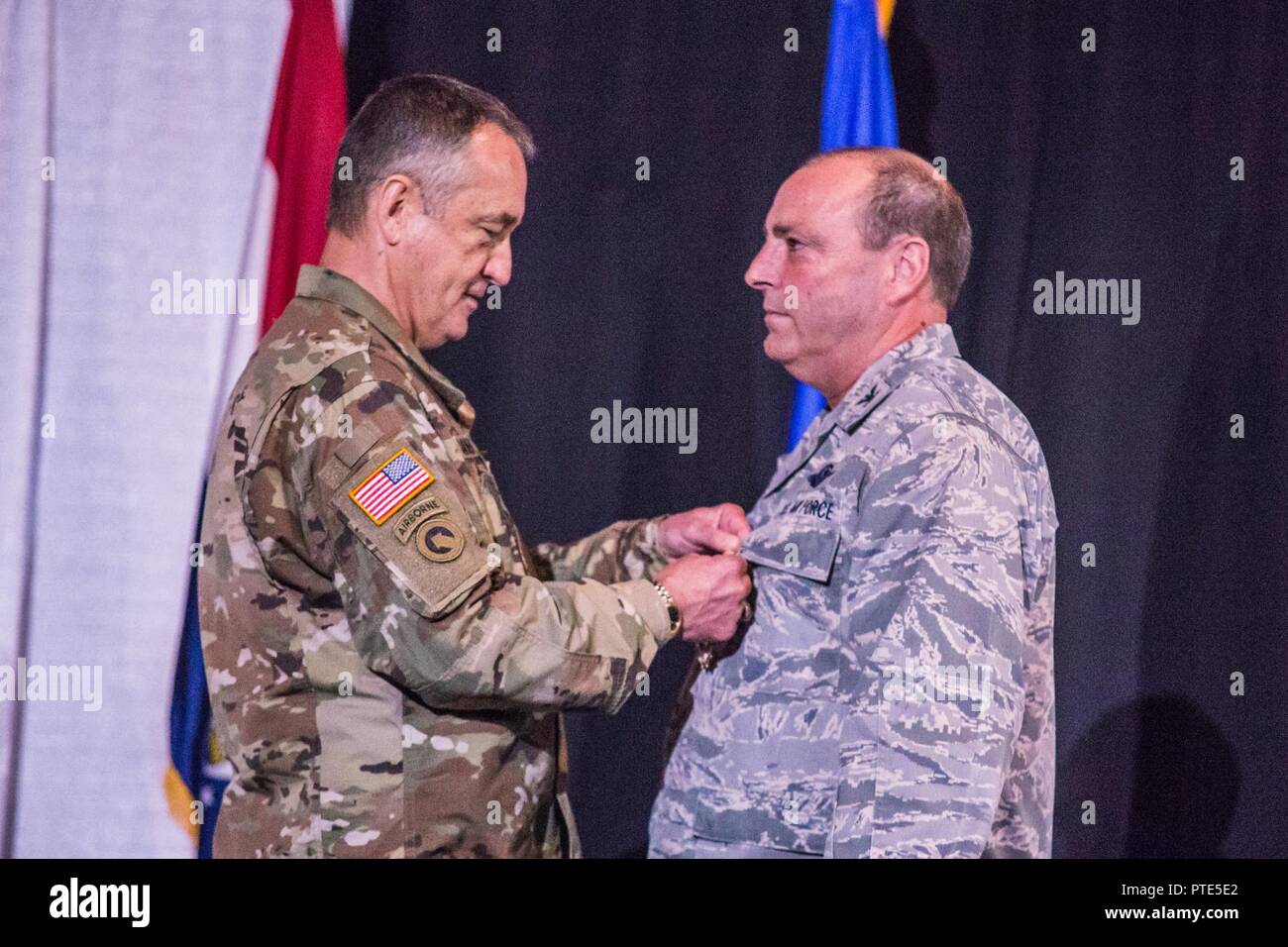 U.S. Army Maj. Gen. Stephen Danner, adjutant general of the Missouri National Guard, presents the Legion of Merit, to Col. Ralph Schwader, commander of the 139th Airlift Wing, Missouri Air National Guard, during a change of command ceremony at the St. Joseph Civic Arena, St. Joseph, Mo., July 8, 2017. Col. Ed Black took command of the 139th AW, from Col. Schwader. Col. Schwader will be assigned to Missouri Air National Guard Headquarters in Jefferson City, after more than 3 years commanding the 139th. Stock Photo