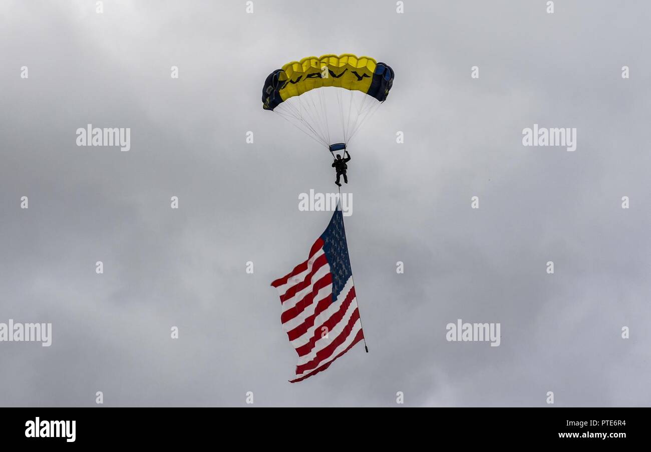 Minnesota (July 13, 2017) Retired U.S. Navy SEAL Jim Woods, a member of U.S. Navy Parachute Team “The Leap Frogs” flies the American flag for a skydiving demonstration above the flat track during at the Summer X Games. The Leap Frogs are based in San Diego and perform aerial parachute demonstrations around the nation in support of Naval Special Warfare and Navy recruiting. Stock Photo