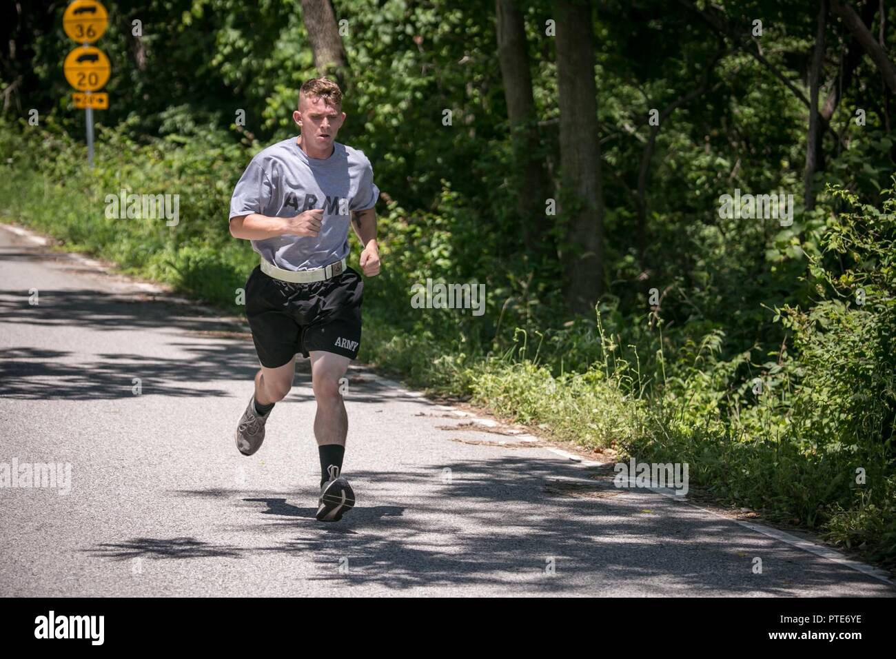 U.S. Army Pfc. Robert Nelson, assigned to 687th Rapid Port Opening Element, runs a 2-mile route during the Army physical fitness test portion of the 2017 Army Materiel Command's Best Warrior Competition July 16, 2017, at Camp Atterbury, Indiana. During the three-day competition, these elite warriors are test on basic and advanced warrior tasks and drills. Stock Photo