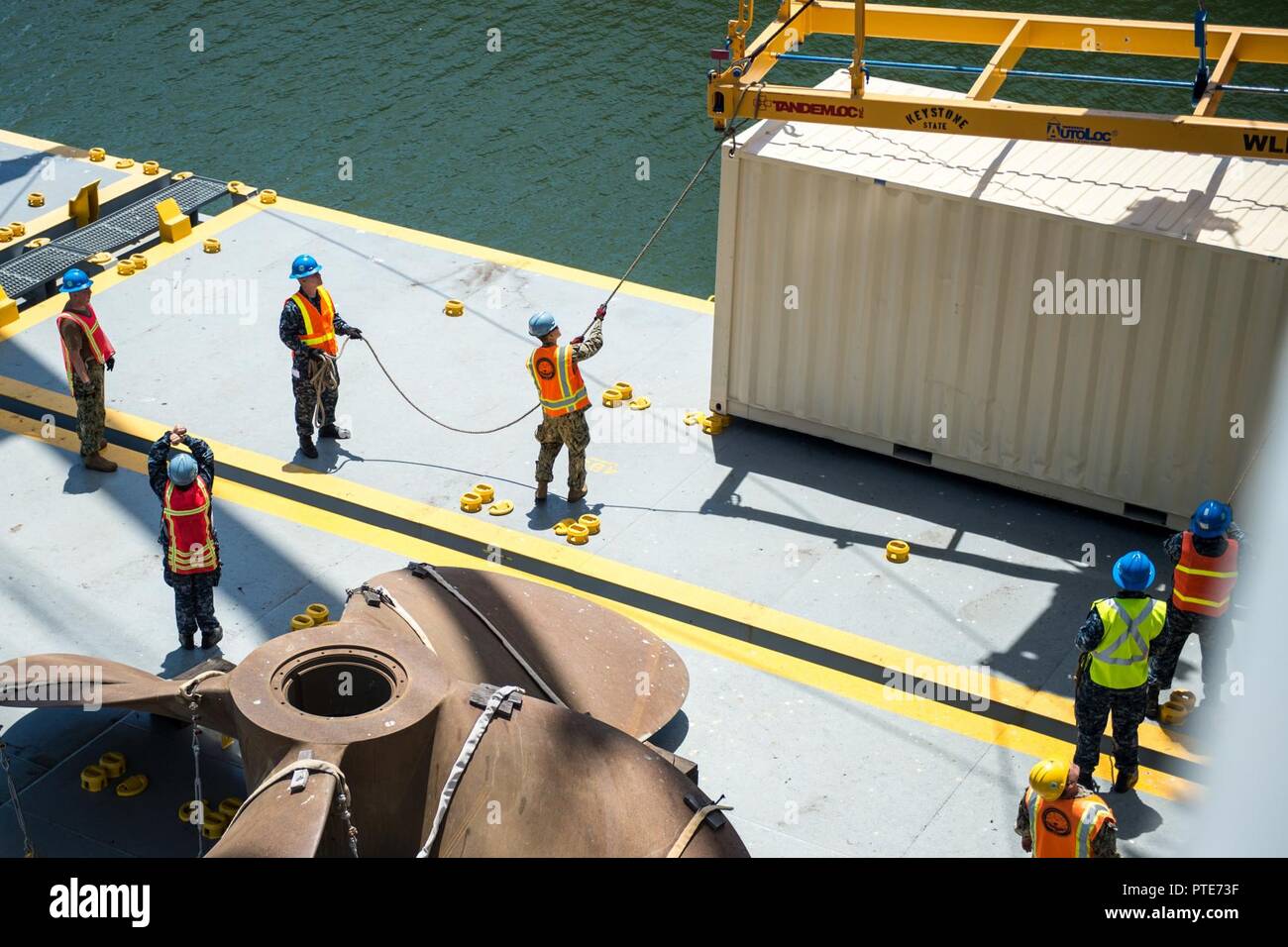 Calif. (July 15, 2017) Sailors from Navy Cargo Handling Battalion (NCHB) 14 receive a container from T-ACS 1 Grand Canyon moored at Alameda Point. Multiple Navy Expeditionary Combat Command (NECC) units participated in a joint exercise designed to train on foundational components of an adaptive force package. Stock Photo