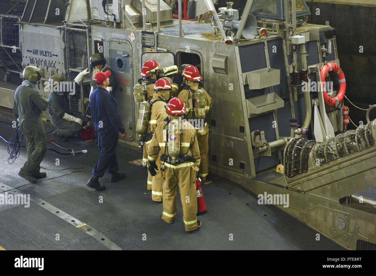 OCEAN (July 15, 2017) Sailors assigned to the Wasp-class amphibious assault ship USS Essex (LHD 2) and Assault Craft Unit (ACU) 5 participate in a fire drill aboard a Landing Craft Air Cushion (LCAC) docked in the ship’s well deck. Essex is underway conducting sea trials off the coast of Southern California. Stock Photo