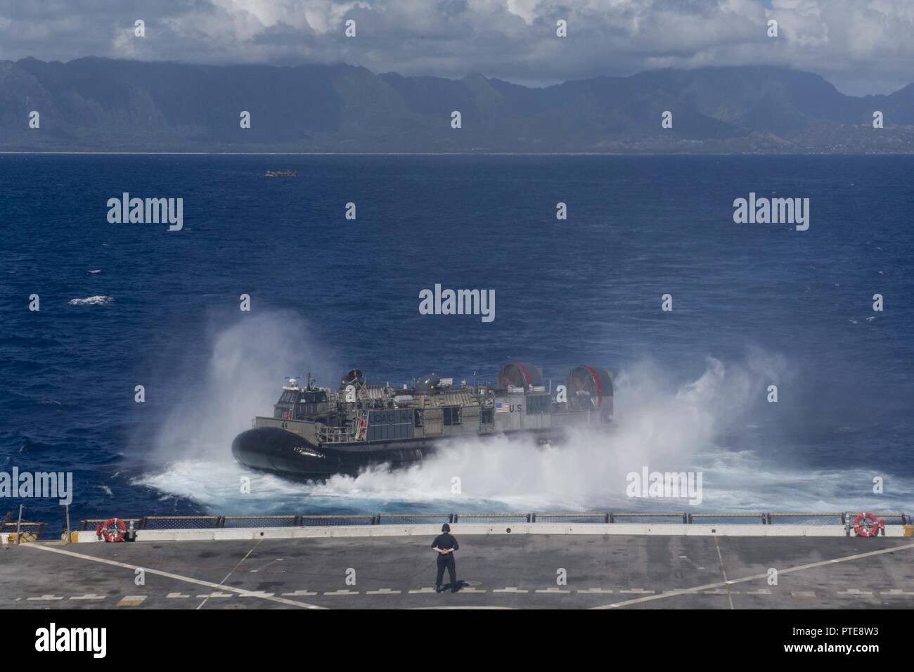 PACIFIC OCEAN (July 15, 2017) A landing craft, air cushion, assigned to the Assault Craft Unit 5 aboard the amphibious transport dock ship USS San Diego (LPD 22) exits the ship’s well deck off the coast of Hawaii during a sustainment exercise. San Diego is embarked on a scheduled deployment as part of the America Amphibious Ready Group, which is comprised of more than 1,800 Sailors and 2,600 Marines assigned to the amphibious assault ship USS America (LHA 6), the amphibious dock landing ship USS Pearl Harbor (LSD 52), and San Diego. Stock Photo