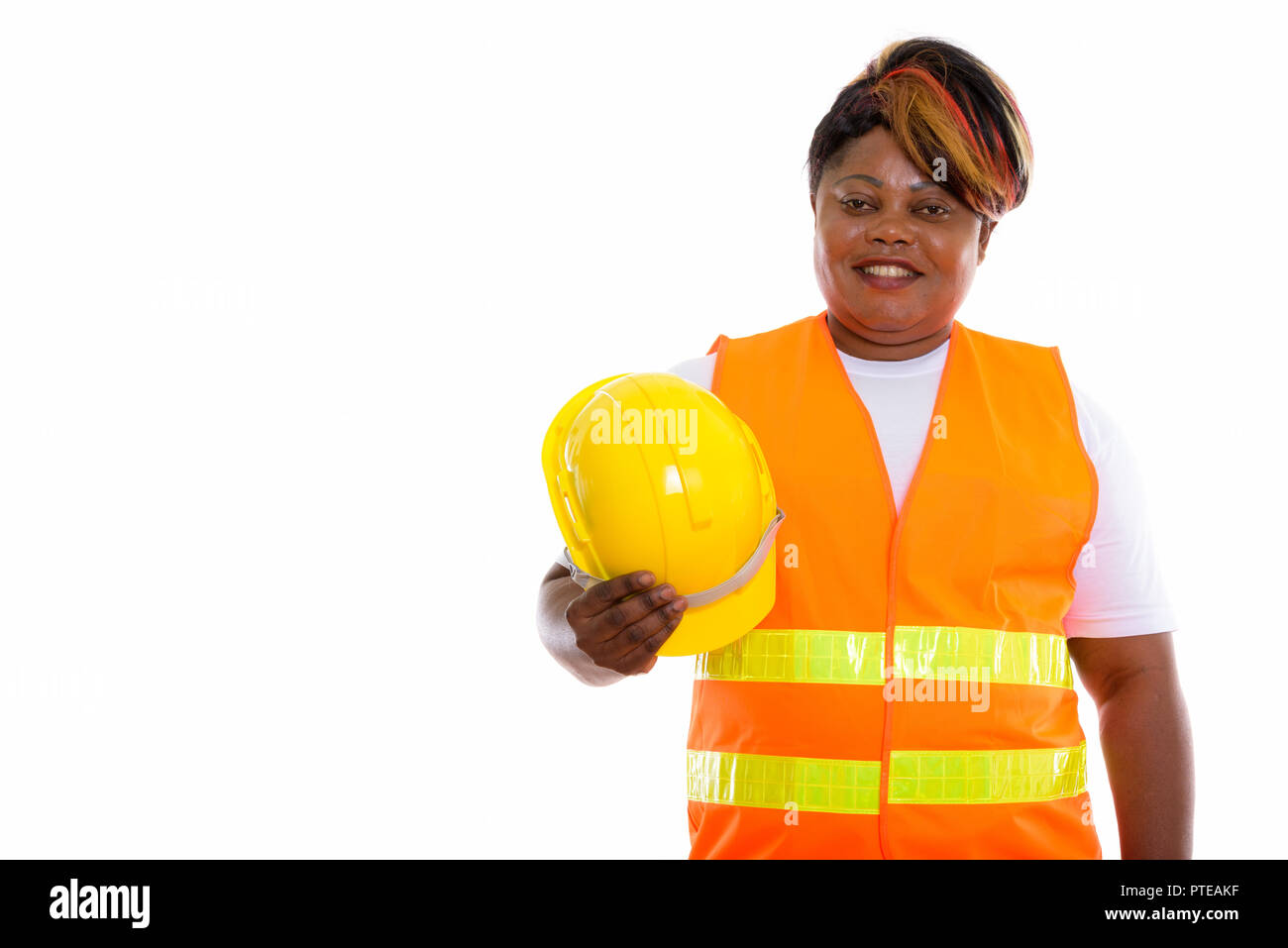 Studio shot of happy fat black African woman construction worker Stock Photo Alamy
