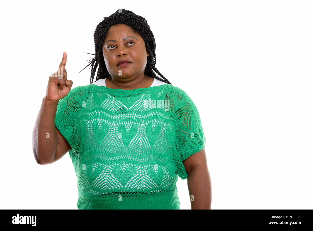 Studio shot of fat black African woman thinking while pointing f Stock ...