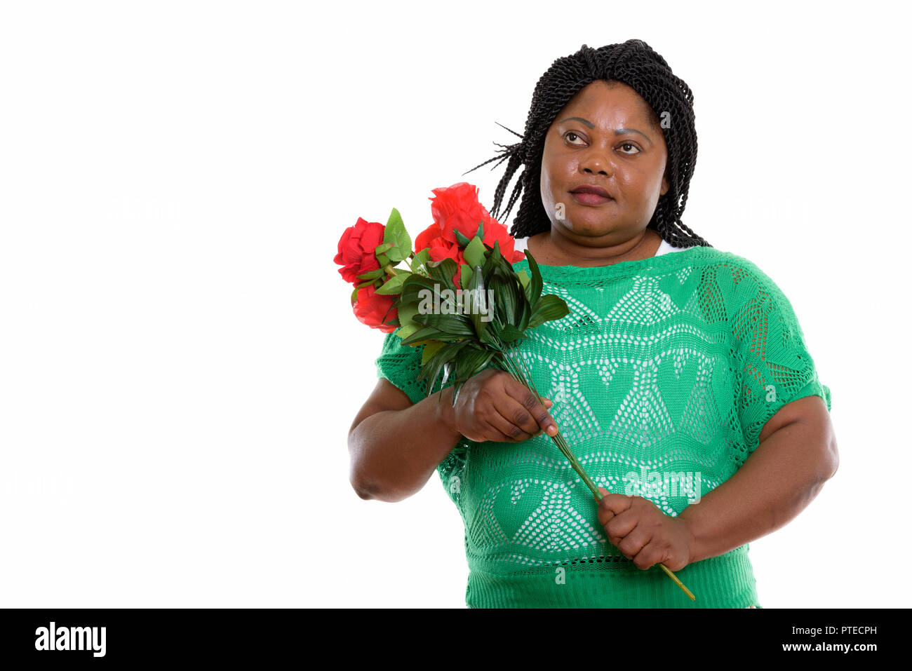 Studio shot of fat black African woman thinking while holding re Stock Photo