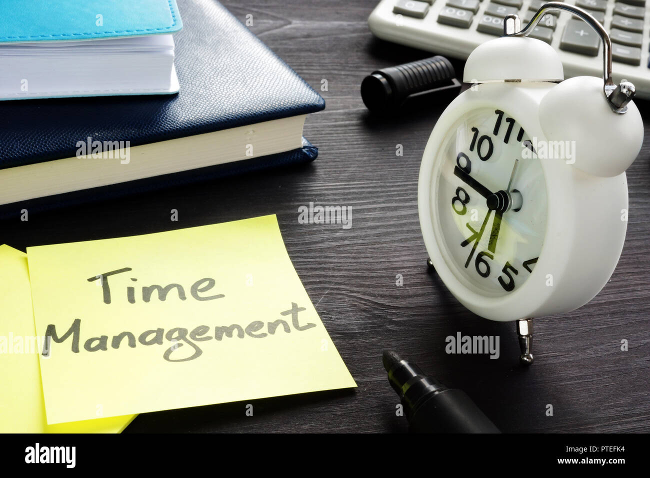 Time management written on a memo and alarm clock. Stock Photo