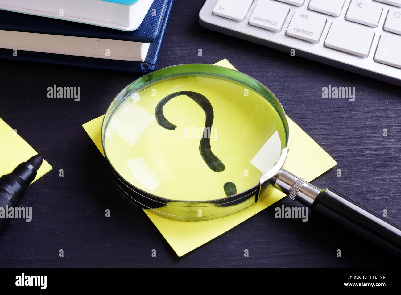 Question mark on a piece of paper. Problem solving. Stock Photo