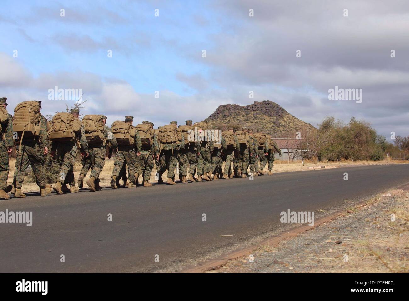 U.S. Marines assigned to 3rd Battalion, 25th Marines, conduct a three mile conditioning hike as part of Shared Accord 17 (SA17) at South African Army Combat Training Center, Lohatla, South Africa, July 16, 2017. SA17 is a Joint bi-lateral Field Training Exercise with our South African partners focused on Peace Keeping Operations designed to exercise participants’ capability and capacity to conduct African Union / United Nations mandated Peace Keeping Operations. Stock Photo